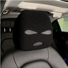Black knitted car headrest cover with eye-shaped cutout design, installed on a car seat in the interior