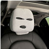 White knitted car headrest cover with eye-shaped cutout design, installed on a car seat in the interior