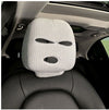 White knitted car headrest cover with eye-shaped cutout design, installed on a car seat in the interior