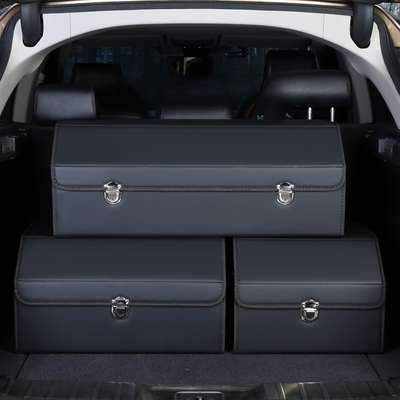 Set of three dark blue leather car trunk storage boxes placed inside a vehicle’s open trunk